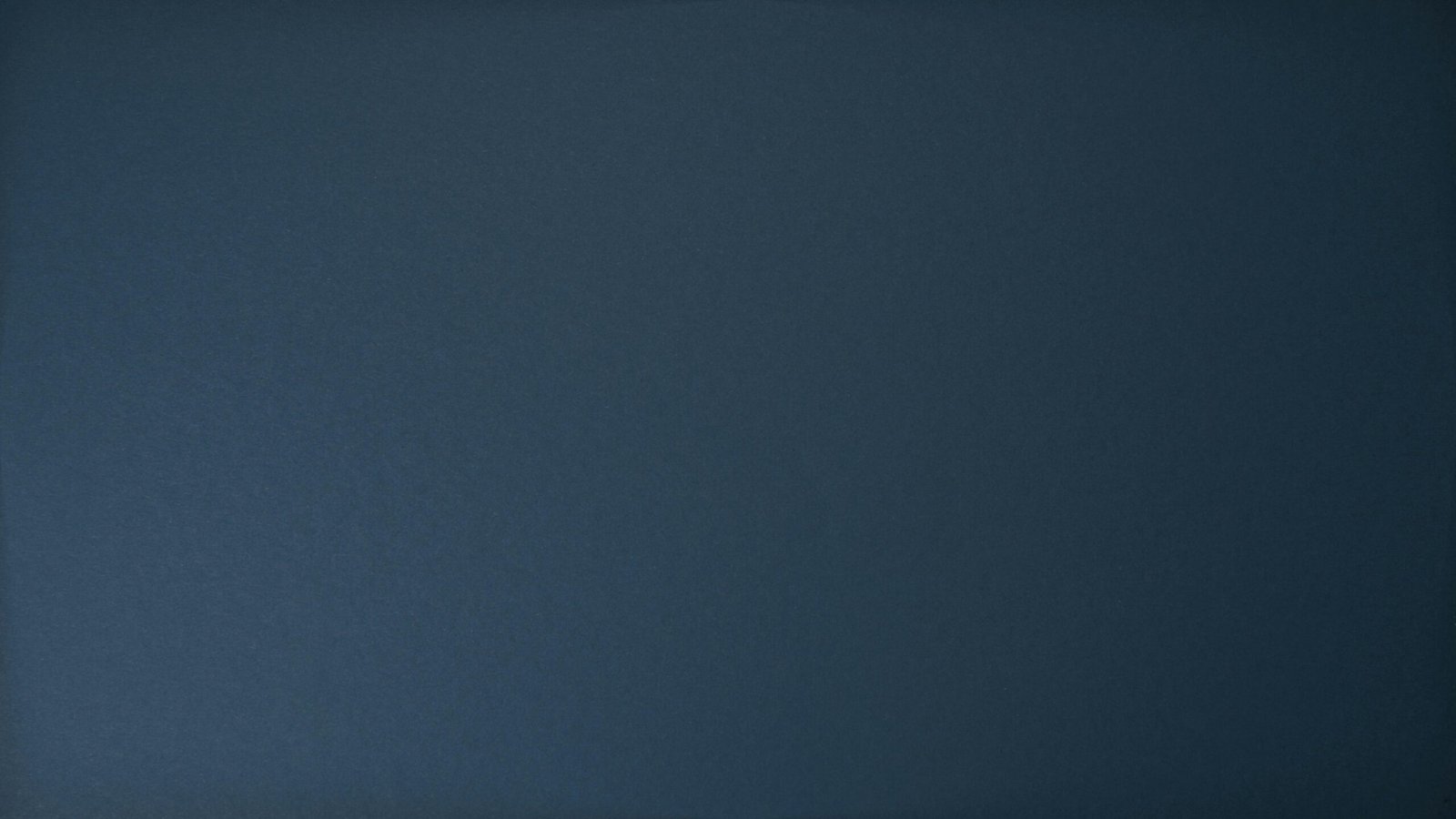 Dark blue textured background perfect for design projects and wallpapers.